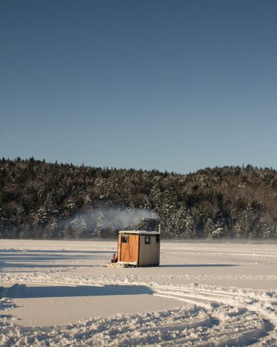 Fish house on frozen lake